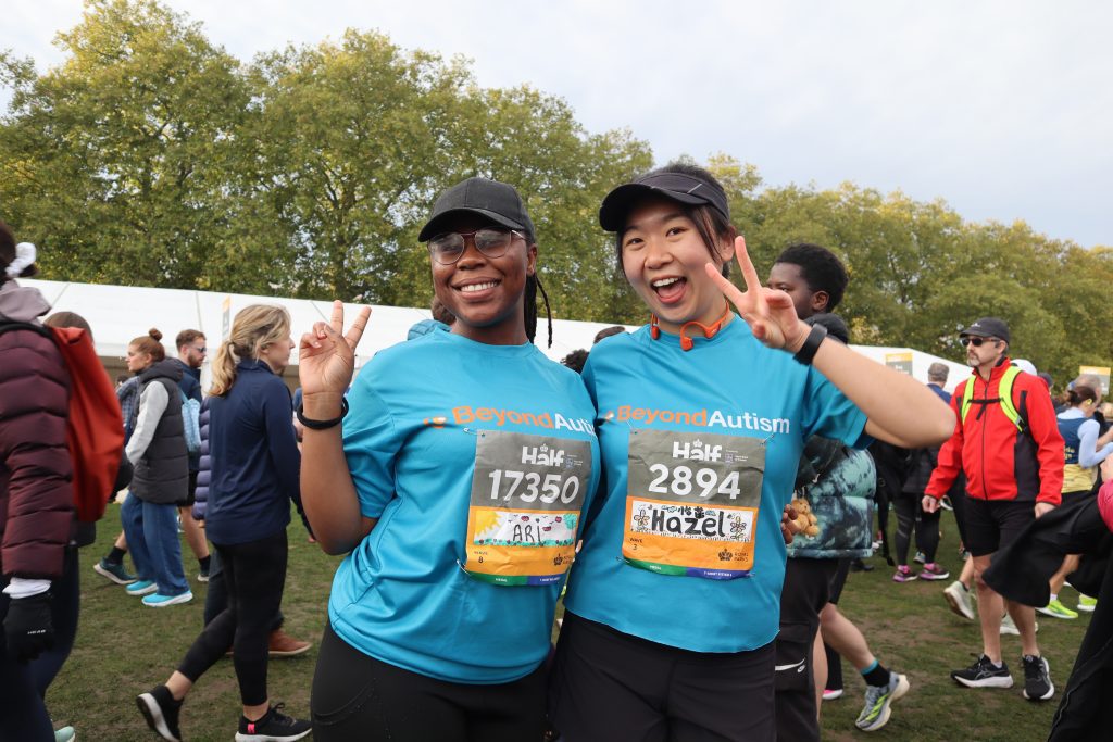 Two women smiling at camera in running kit